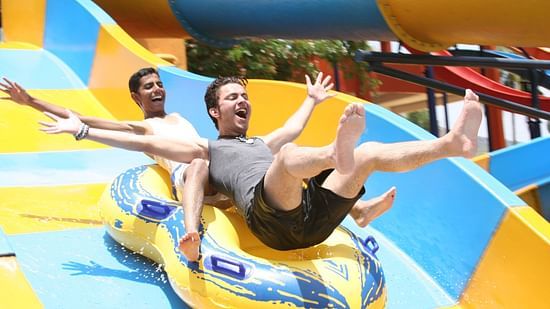 Family Broad Slide with two men joyously sliding down - The Black Thunder