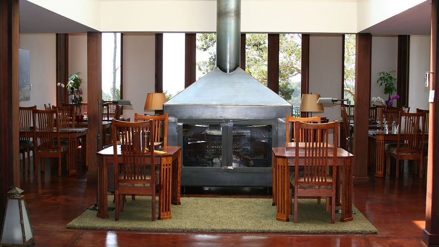 A cozy dining area with a grand central fireplace for the ultimate warm welcome - Brewery Gulch Inn & Spa