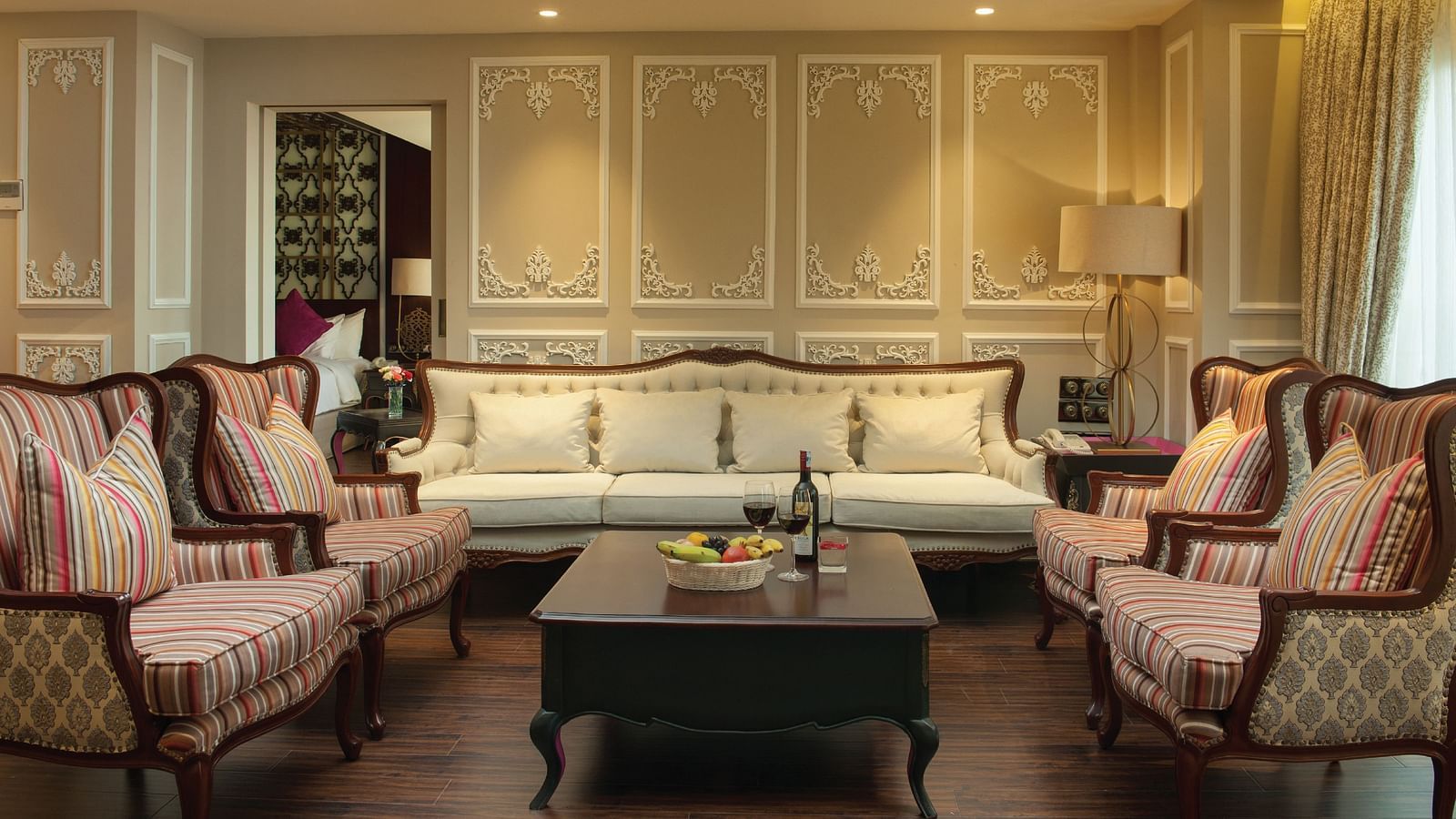 Separate living room with furniture arranged around the table, warmly lit to create a welcoming atmosphere