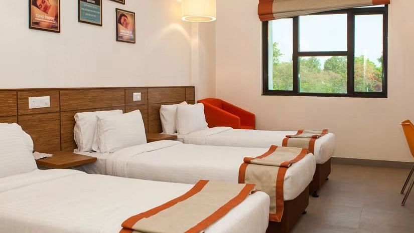 Max Club Room Hotel - Hotel room with three single beds, modern decor, wall art, and a window offering natural light