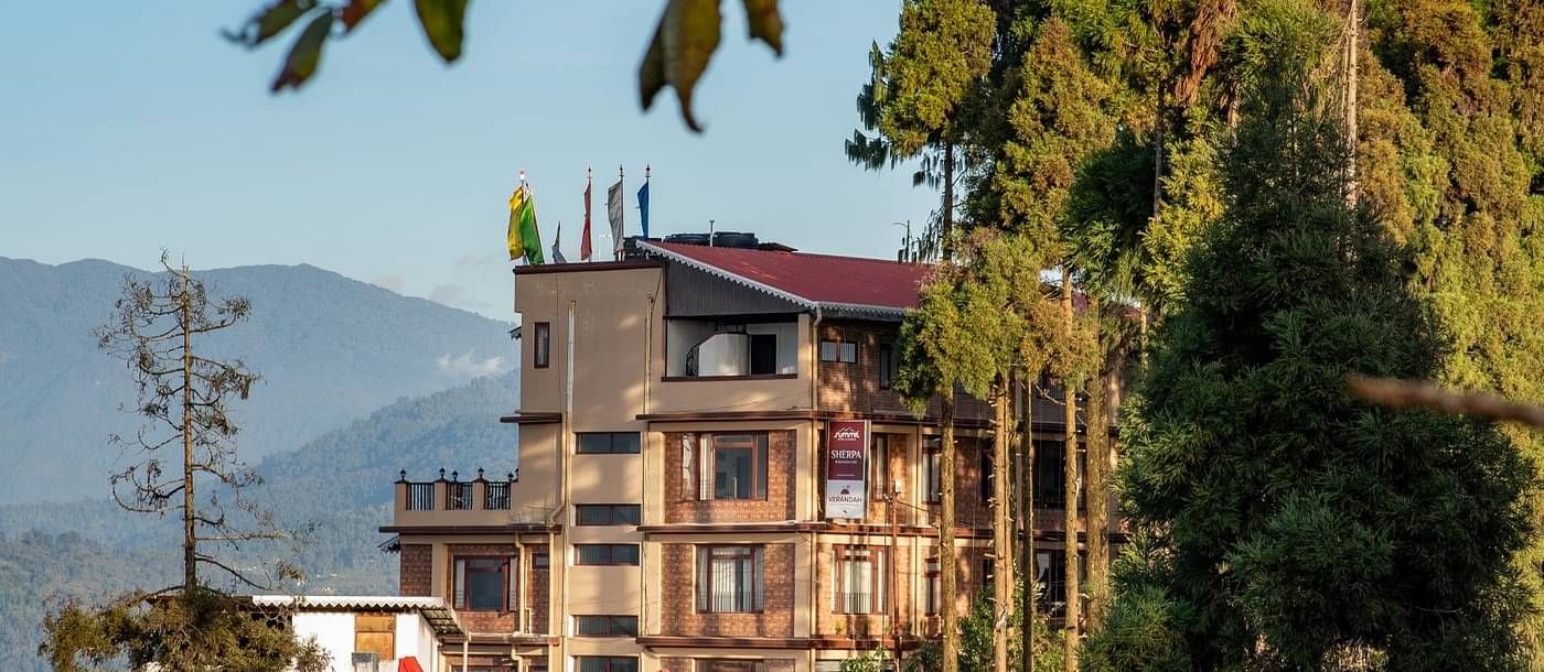 facade image of sherpa mountain hotel in kalimpong on a bright morning