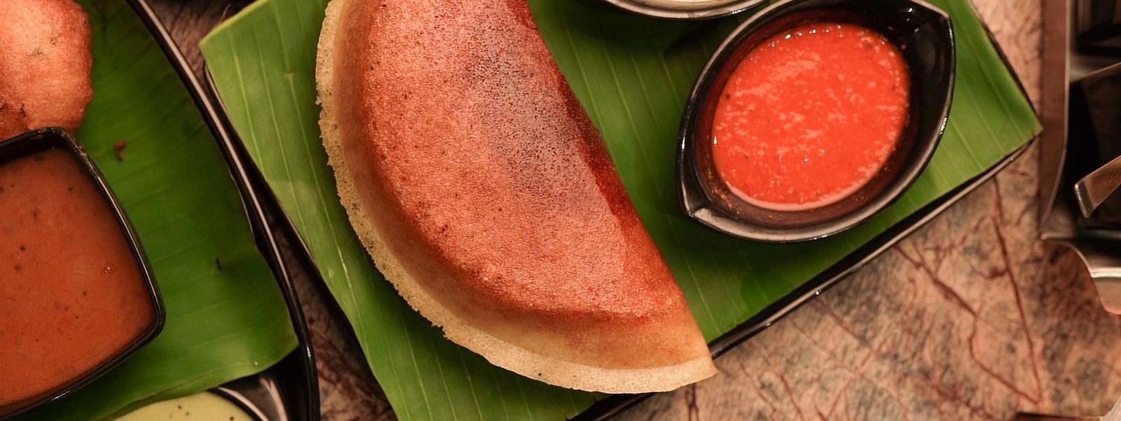 An image of dosa served with curd and pickle - Pai Group of Hotels