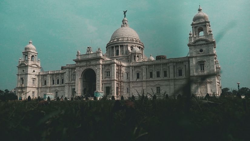 Victoria Memorial building made with white marble with a garden in foreground
