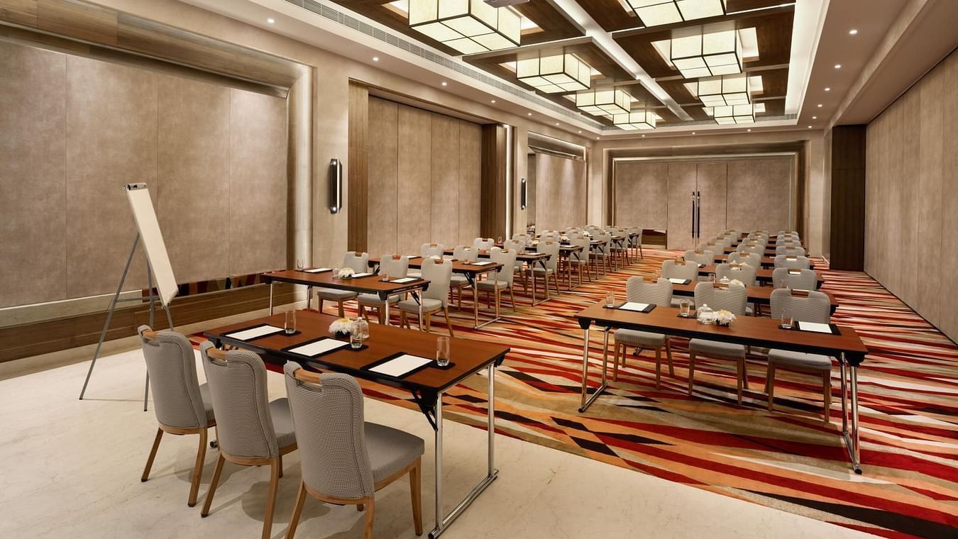 Classroom setup with a head table and stylish ceiling lights at The Residency Towers Coimbatore.