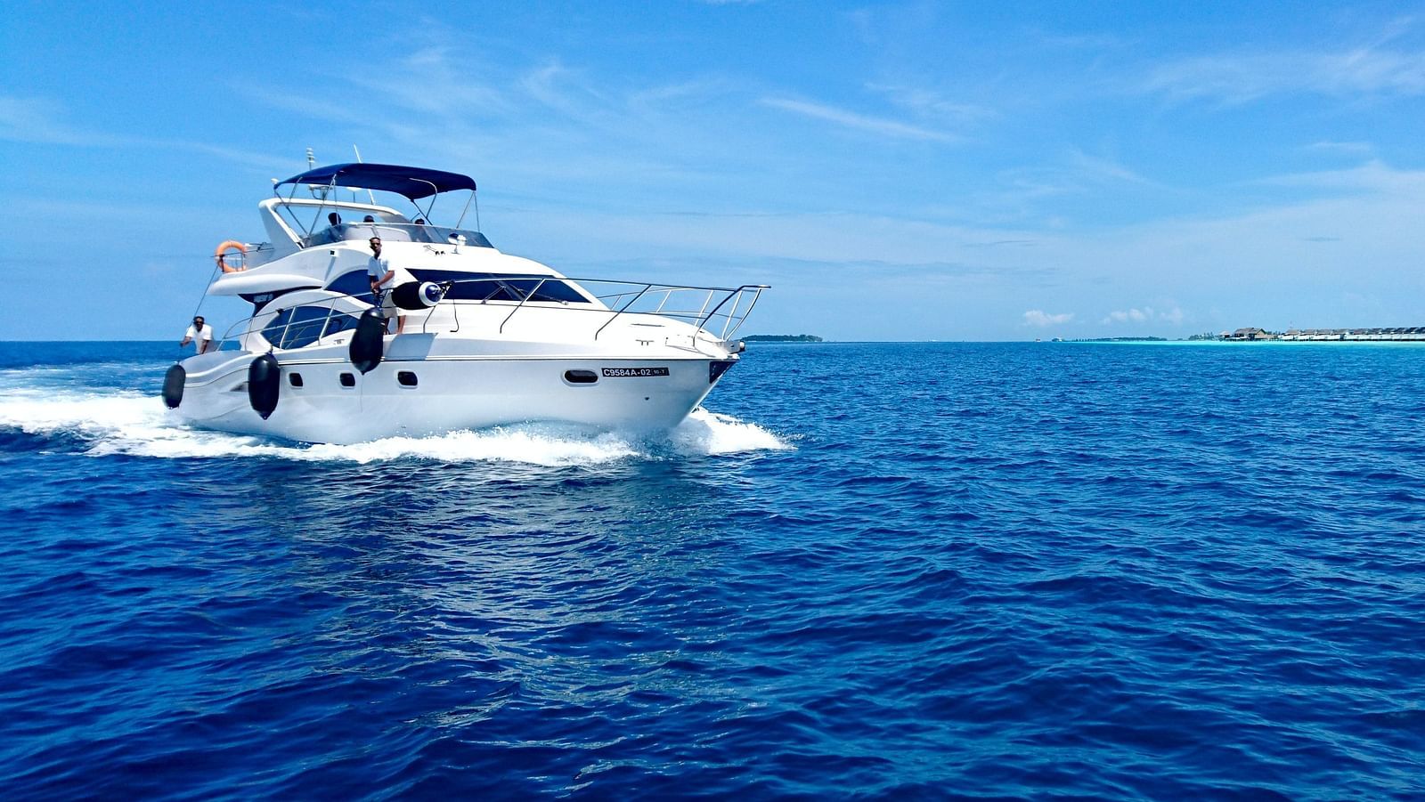 image of a yacht in the sea with the blue sky in the background
