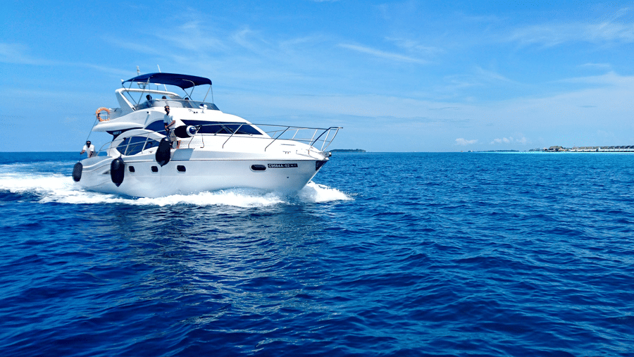 image of a yacht in the sea with the blue sky in the background