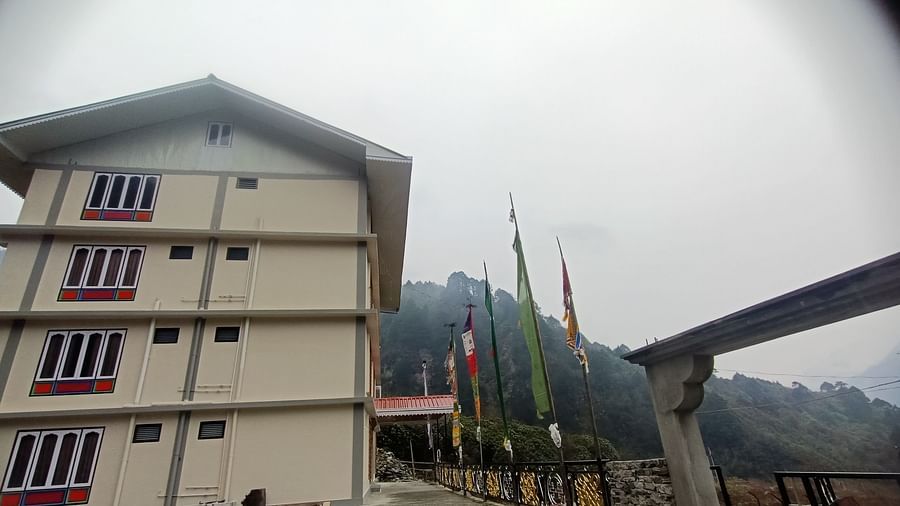 Facade of Ecotel Sonam Lachung surrounded by lush green hills