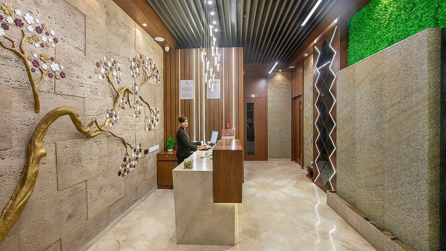 A stylish hotel corridor with textured walls and subtle lighting features - SK Lords Inn Ahmedabad