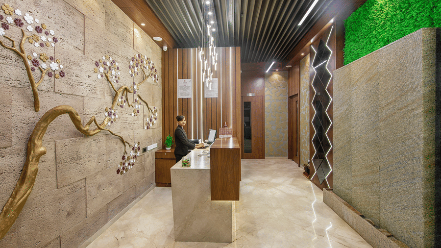 A stylish hotel corridor with textured walls and subtle lighting features - SK Lords Inn Ahmedabad