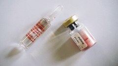 A syringe and medicine kept on a table