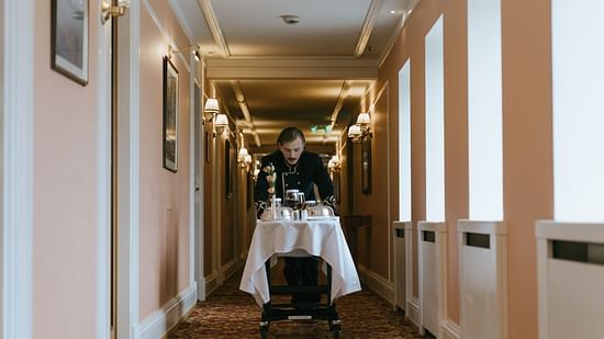 A hotel staff bringing food to the room
