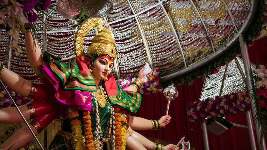 Idol of goddess Durga fully decorated in in silk clothes and flowers