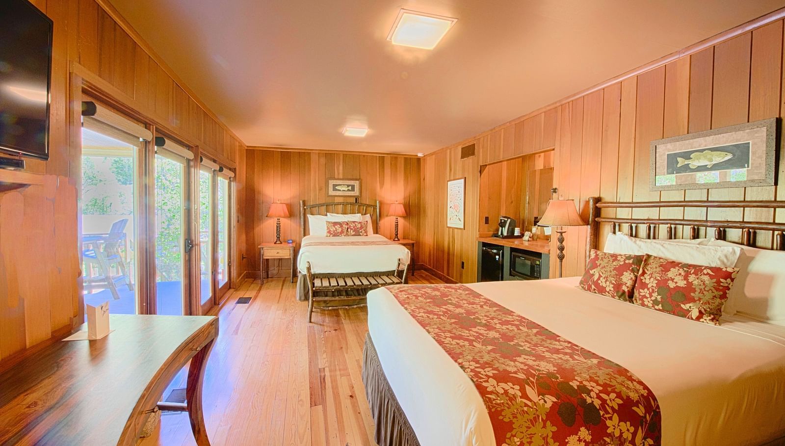 a room with ample of natural light coming from the huge windows featuring two comfortable double beds - Historic Tapoco Lodge