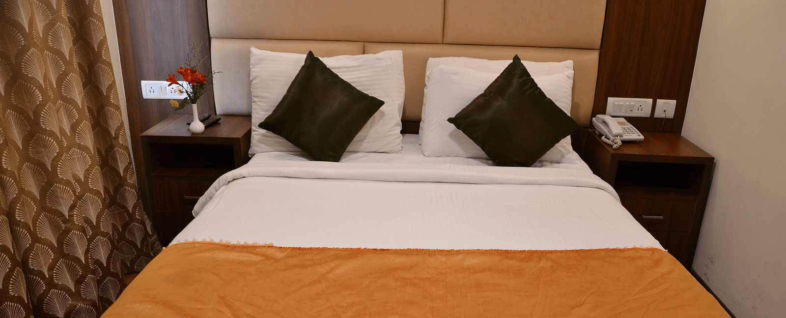 A comfortable bedroom with soft lighting, plush pillows, and a warm colour scheme for restful nights - Benzz Park, Kodaikanal