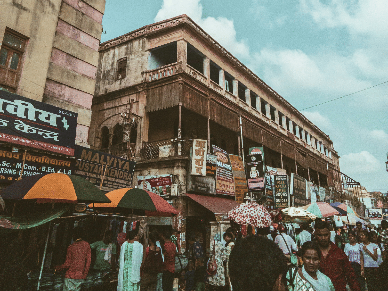 people walking around a bazaar during the day