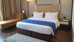 An image of a bedroom with king size bed with bedside table on each side-Hotel Polo Towers, Agartala 