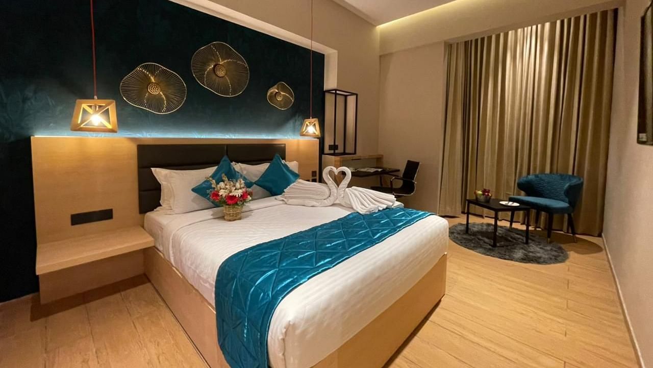 Double bed with blue sheets at Premium Room at Le Foliage by TGI, Bangalore