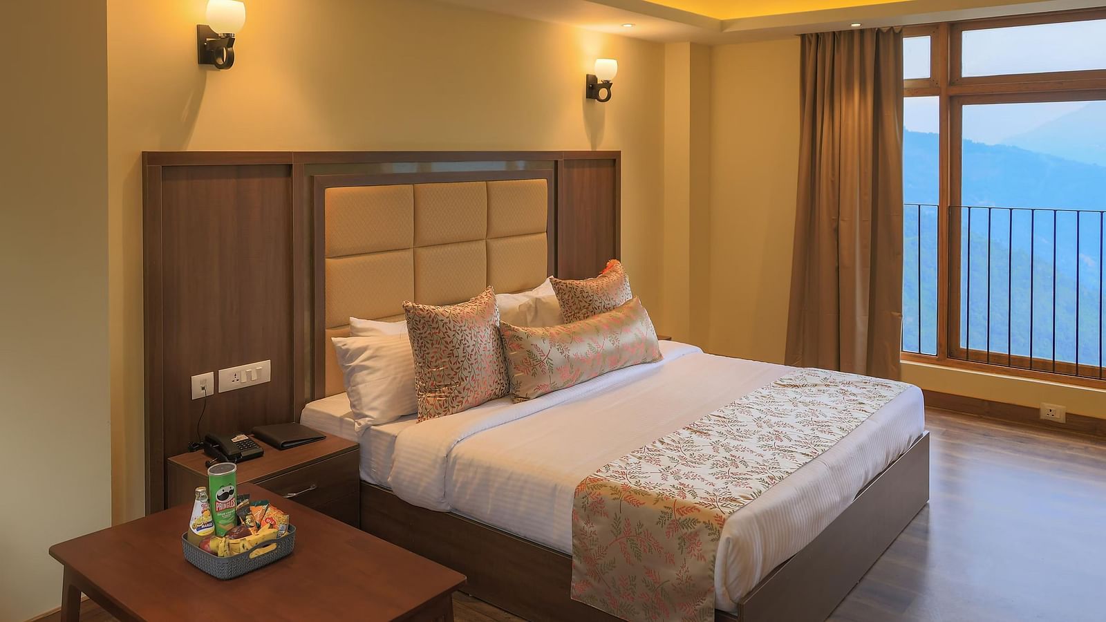a Premier Room featuring a queen size bed with a cushioned head board at Yashshree Karbari Resort & Spa, Yangang