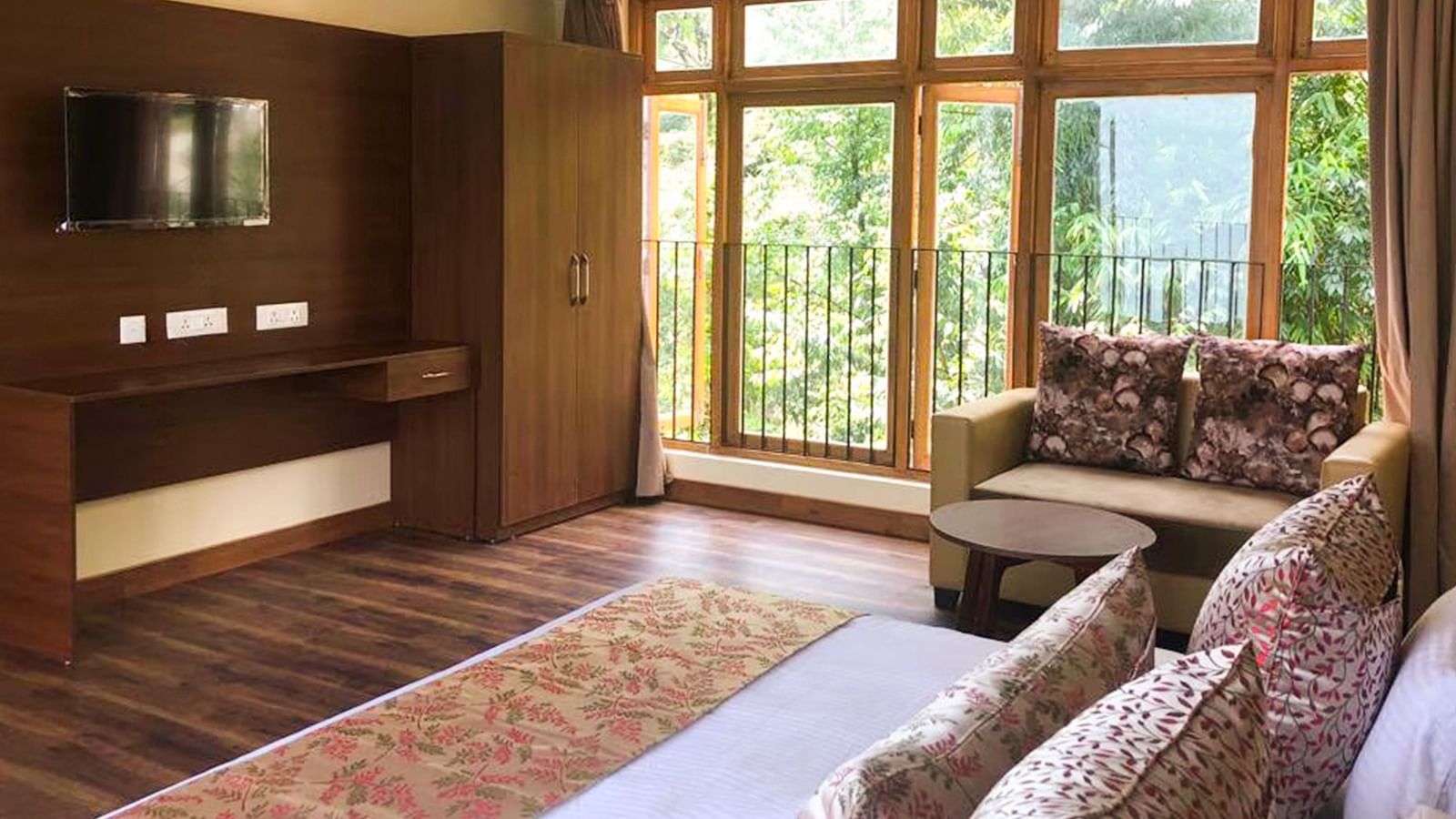 full view image of the Premier room with balcony at Yashshree Karbari Resort & Spa, Yangang with beautiful views outside the balcony