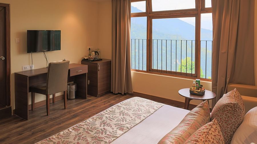the Deluxe triple room with beautiful mountain views from the window at Yashshree Karbari Resort & Spa, Yangang