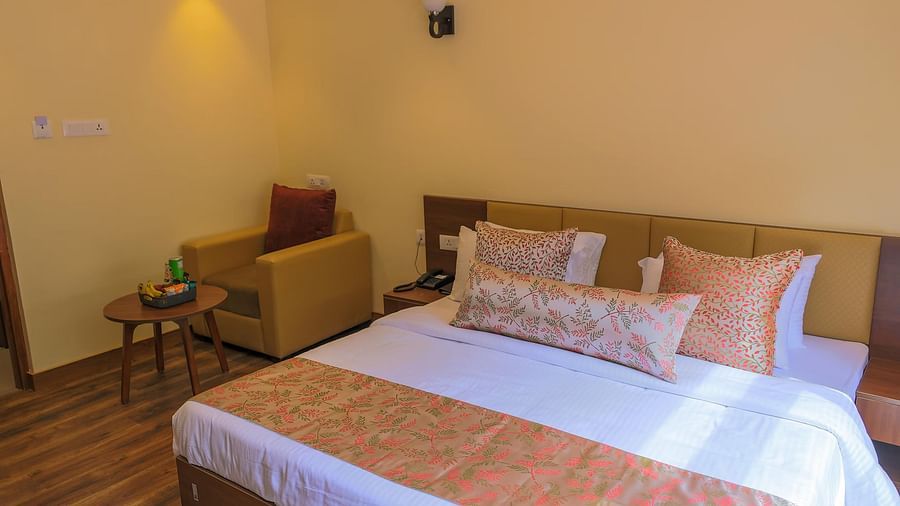close up image of the double bed at the Deluxe triple room with a single couch at the corner of the room