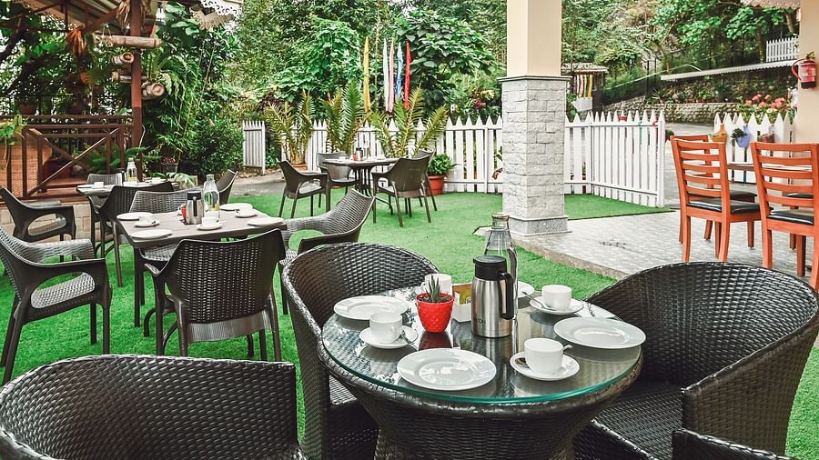 seating area in the garden of Yashshree Karbari Resort & Spa, Yangang featuring glass top tables