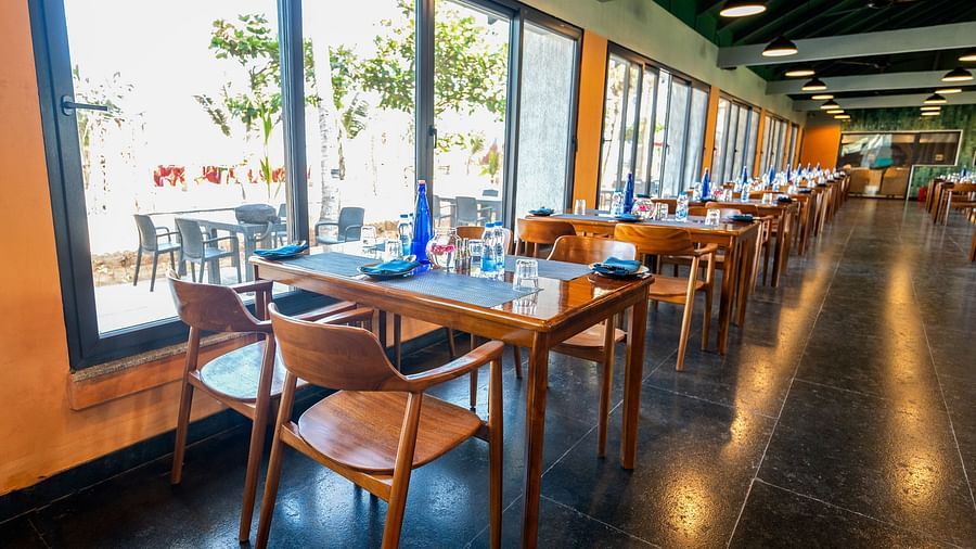 Window-side dining tables at Song of the Sea restaurant during daytime.