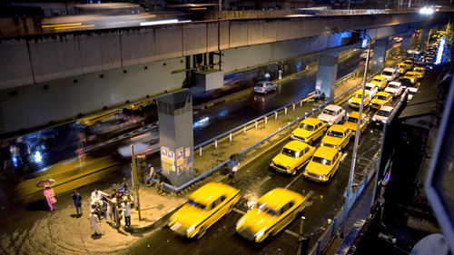 overhead view of many yellow taxis in queue to fetch passengers