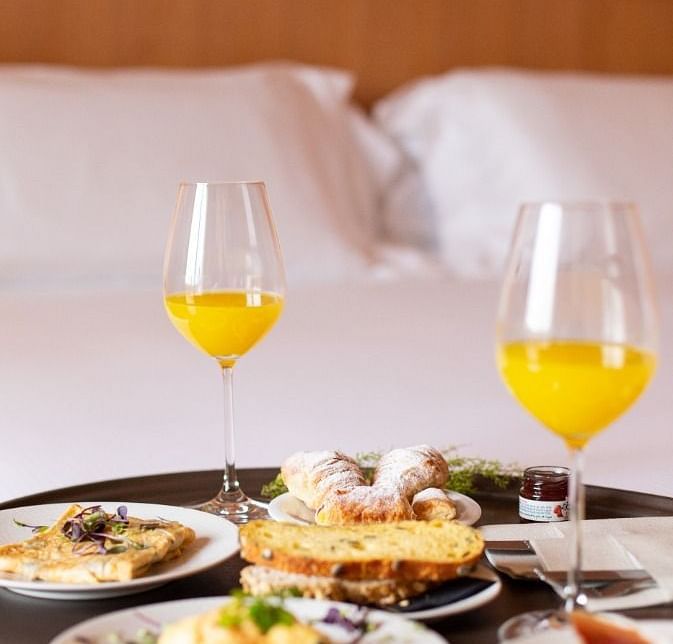A delicious meal on a room service tray placed on the bed at Ocean Spray, Puducherry