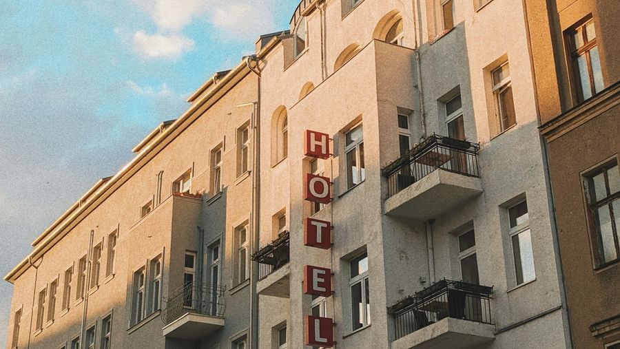  A low-angle view of a row of European-style buildings with balconies under a blue sky