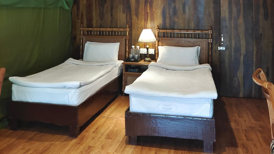 front view of a tent with two single beds and a single side lamp - The Jamoon, Corbett