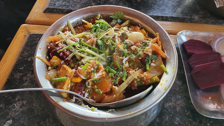 Fresh curry with mixed greens, toppings, and a side of rice bowl at Dagshai Manor Kasauli - Inde Hotels.