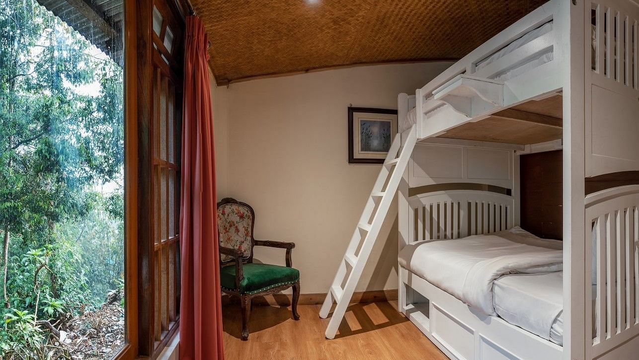 A room at Summit Barsana Resort & Spa, Kalimpong with bunk beds and large windows