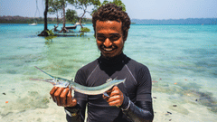 A man standing with a fish