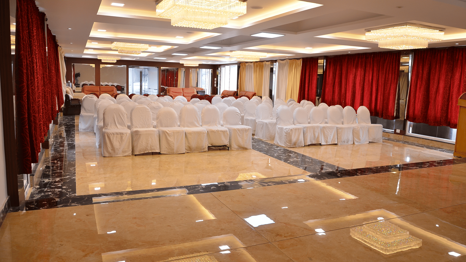 A banquet hall with bright lights and organised seating, perfect for conferences and celebrations - Benzz Park, Kodaikanal