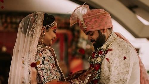 bride and groom smiling and holding hands