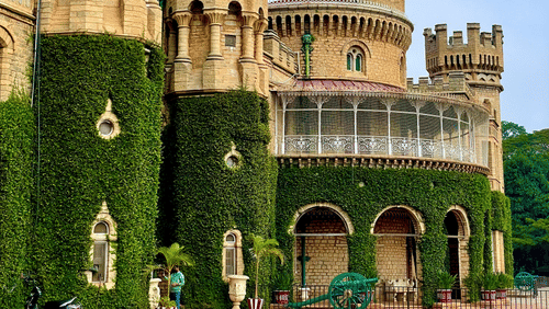 Historic stone palace with towers and arched entrances under a clear sky.