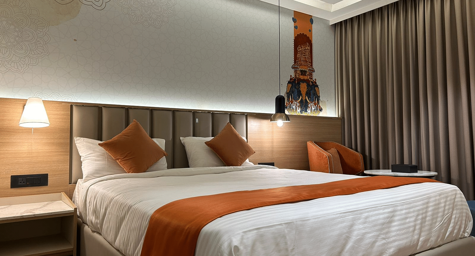 A room featuring a bed, bedside tables, and lamps - TGI Oberon, Koramangala