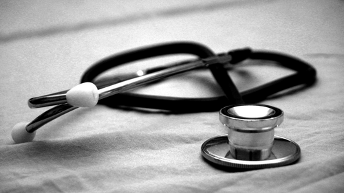 A black and silver stethoscope resting on a white surface representing healthcare services at Ananta Express, Katra.
