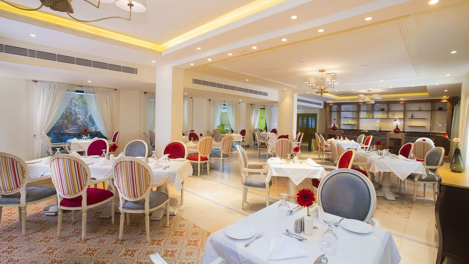 Fine dining area with numerous chairs and tables set and ready for guests.