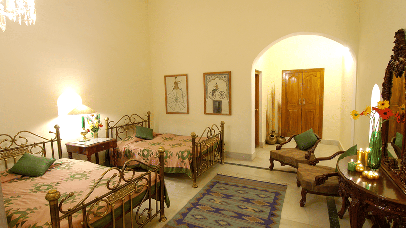 Standard Room featuring bedroom with two large beds and a table and chairs - Hotel Castle Mandawa, Jhunjunu