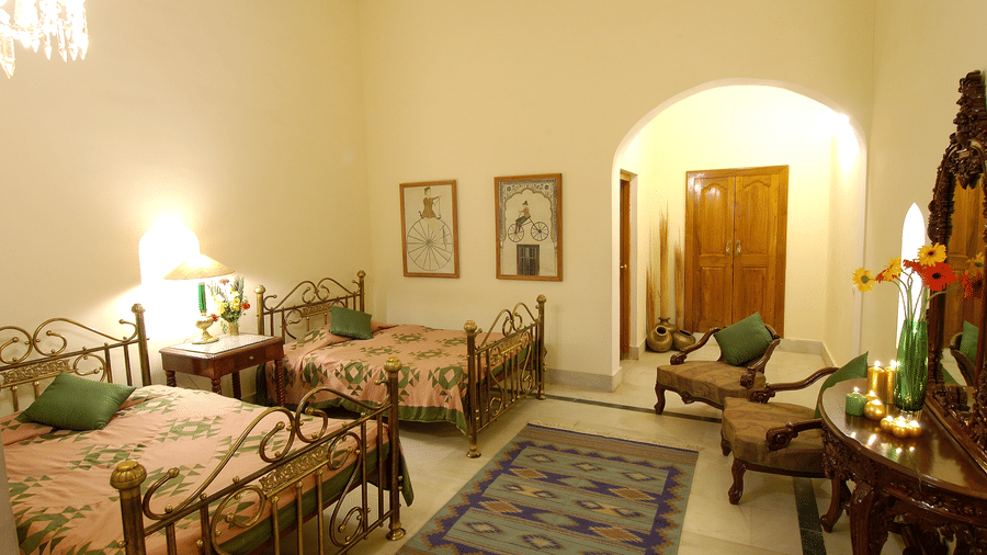 Standard Room featuring bedroom with two large beds and a table and chairs - Hotel Castle Mandawa, Jhunjunu