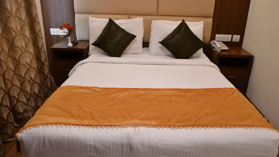A comfortable bedroom with soft lighting, plush pillows, and a warm colour scheme for restful nights - Benzz Park, Kodaikanal