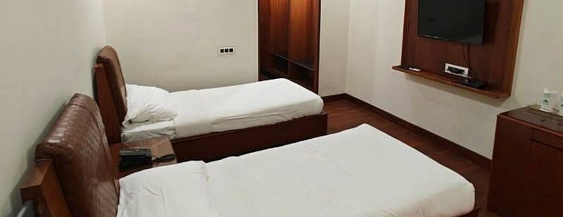 The Luxury Room from a higher angle featuring a wall mounted television in front of it - Hotel Gold, Panipat