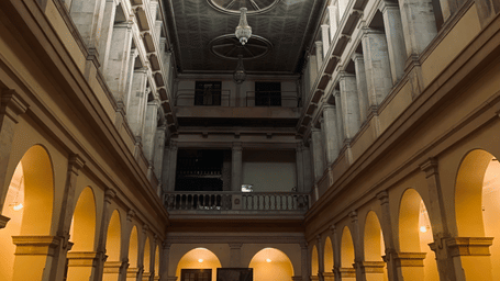 Interiors of Lal Bagh Palace in Indore featuring high ceiling with chandeliers hanging and large skylights