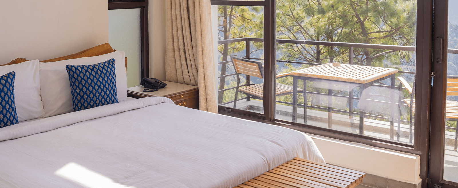 A bedroom featuring balcony at BluSalzz Escapade Resort, Lansdowne