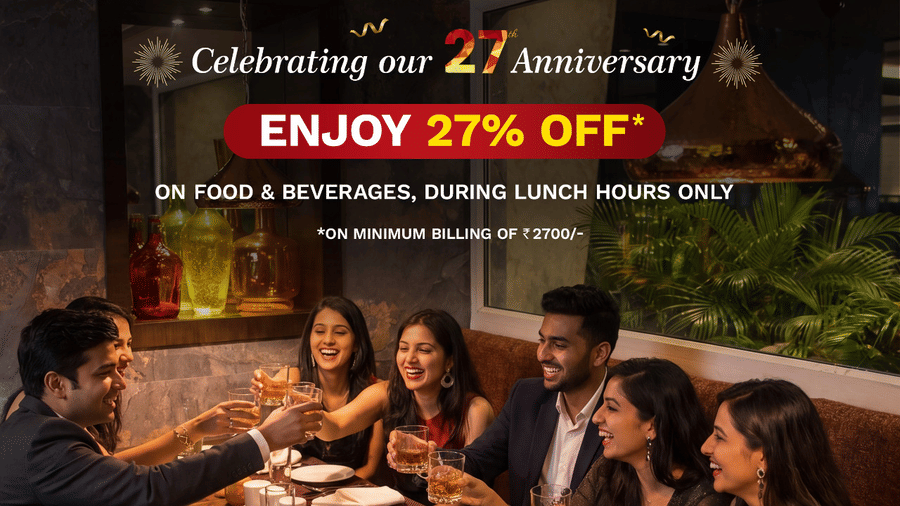 Friends and family raising a toast at Equinox restaurant, The Sonnet Jamshedpur, celebrating 27% off on food and beverages during the 27th Anniversary lunch offer