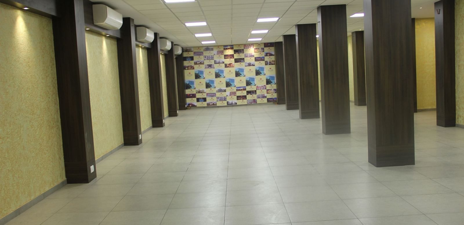 Spacious banquet hall with tiled flooring and decorative wall