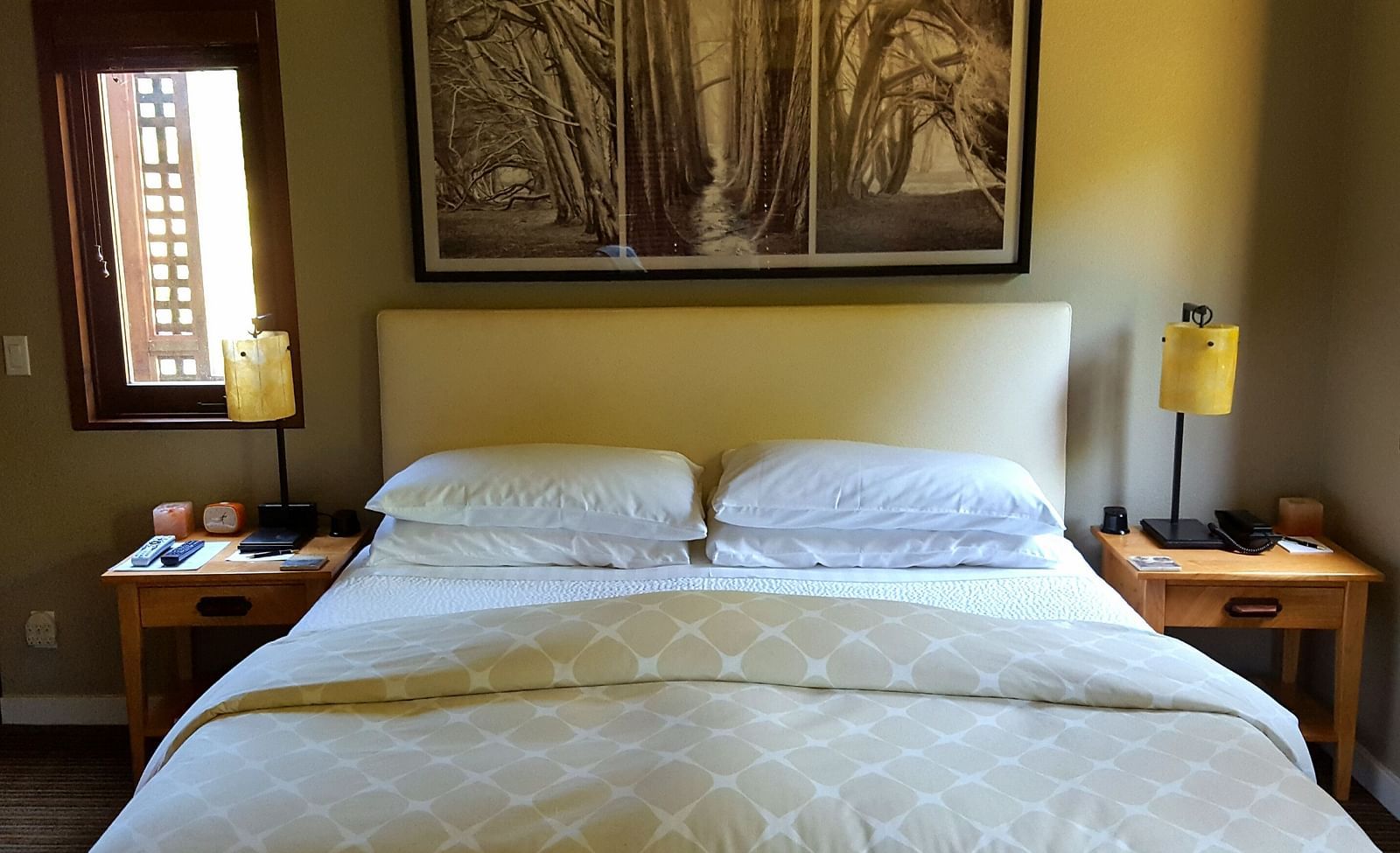 A charming bedroom featuring a large bed, wall-mounted paintings, soft lighting and elegant decor - Brewery Gulch Inn & Spa