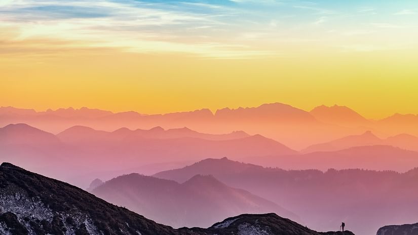 A view after the sunset with mountain ranges and different coloured hues in the sky